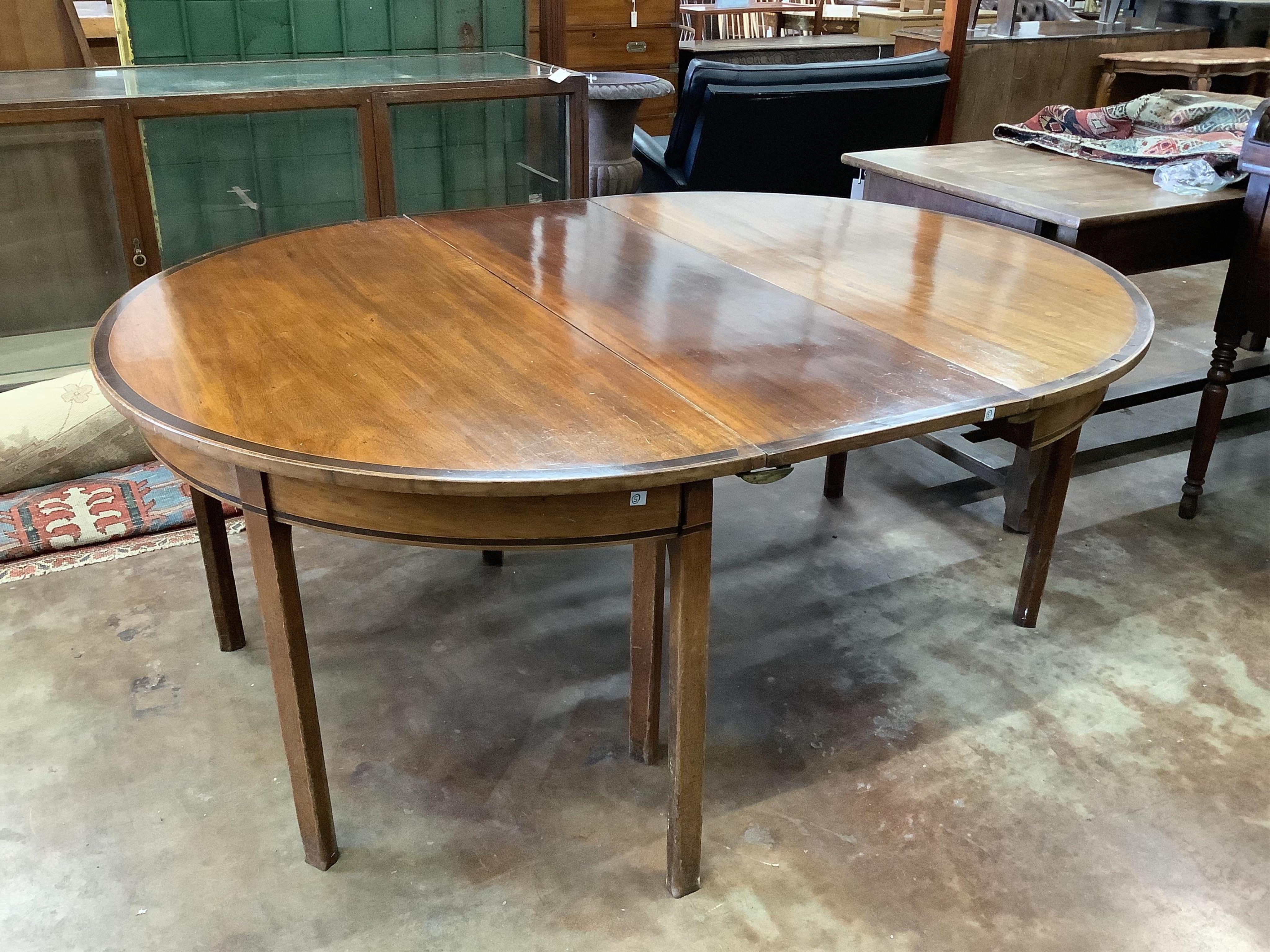 A George III banded mahogany D end extending dining table, 178cm extended, one spare leaf, depth 137cm, height 72cm. Condition - fair